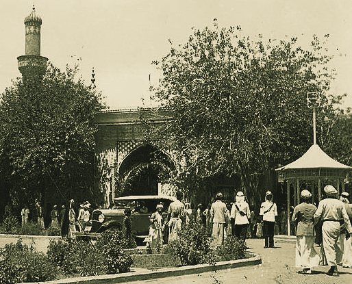 Crowds outside a tiled, arched gate in Baghdad, 1935